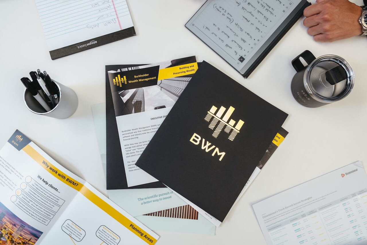 bwm-materials-optimized Burkholder Wealth Management financial-planning materials arranged on a desk.